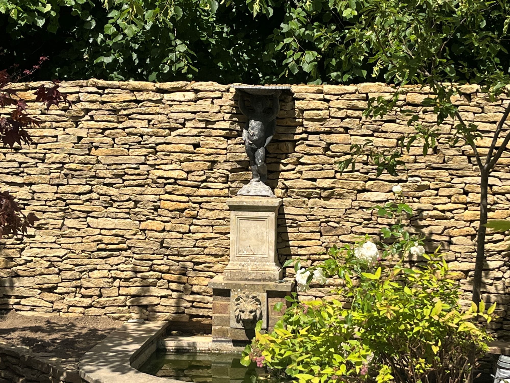 A dry stone wall sets off the courtyard garden