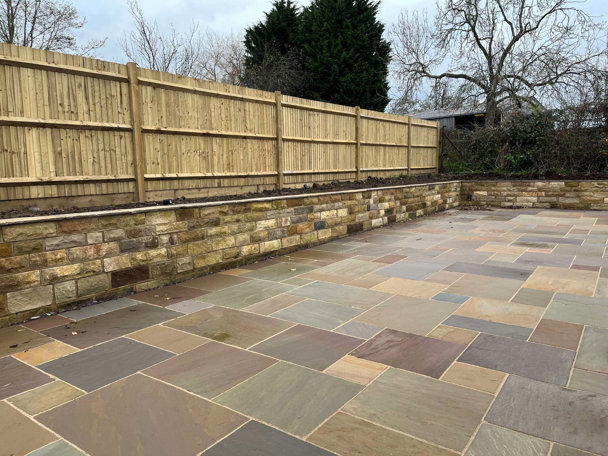 Cropped Yorkstone walling and Sahara buff Sandstone Paving
